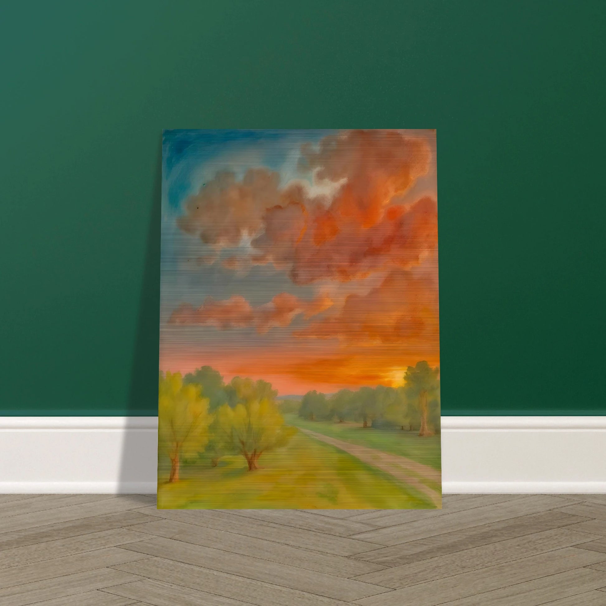 Soft orange clouds drift above a winding country path, with green trees and fading sunlight across open fields.