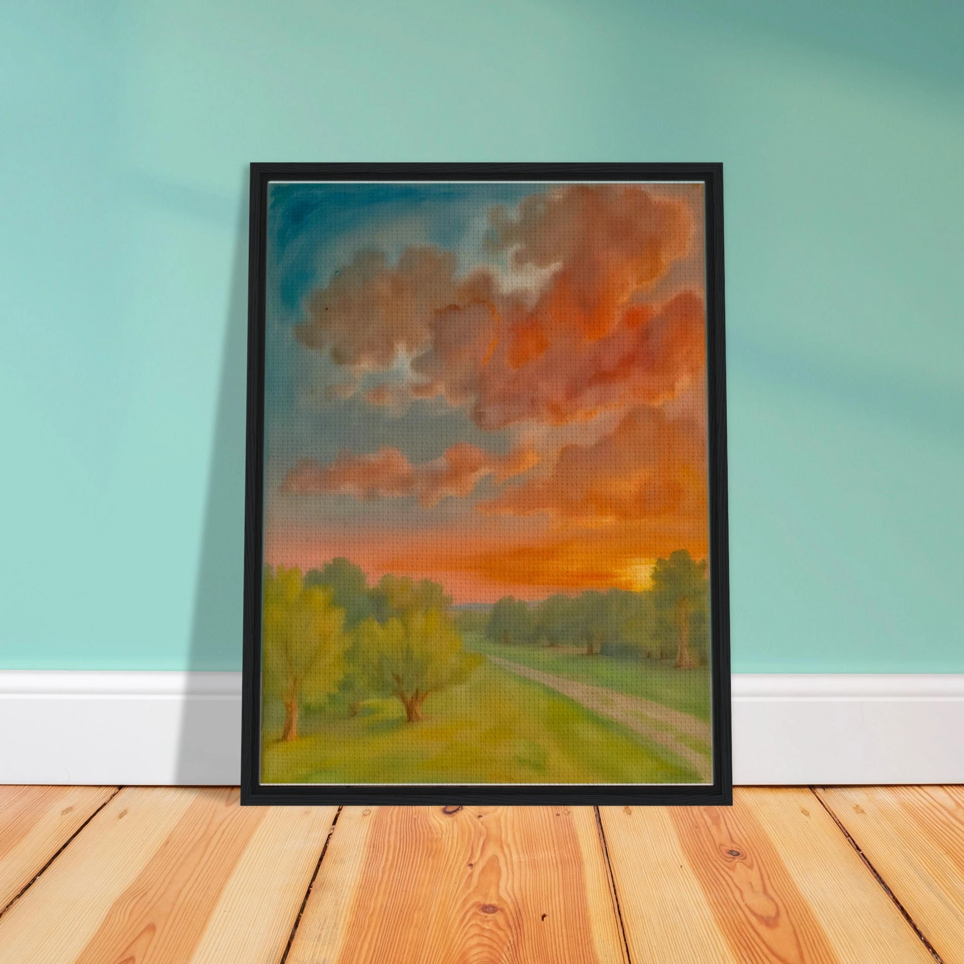 Soft orange clouds drift above a winding country path, with green trees and fading sunlight across open fields.