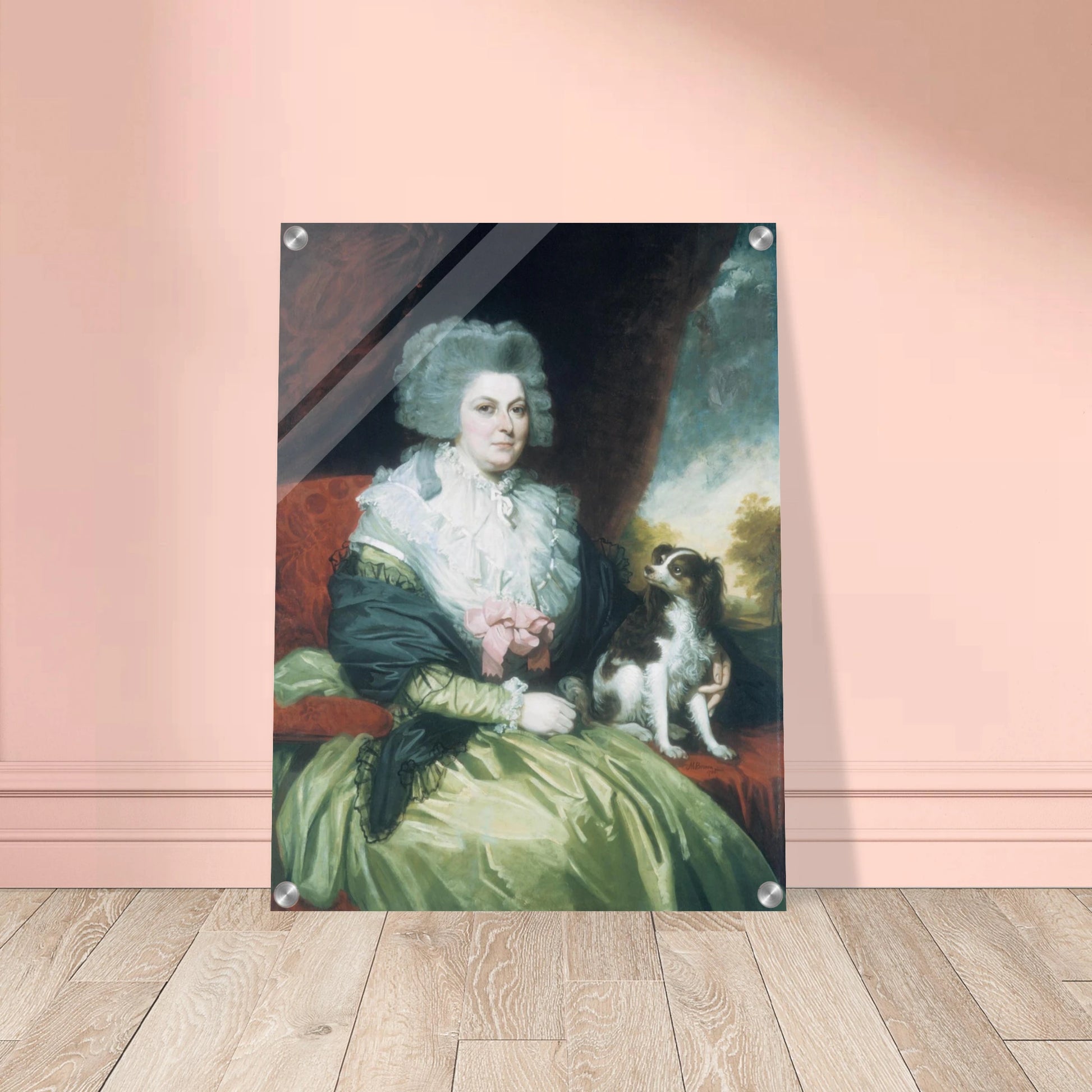 Woman in a green dress sits beside a small black and white dog in a formal portrait