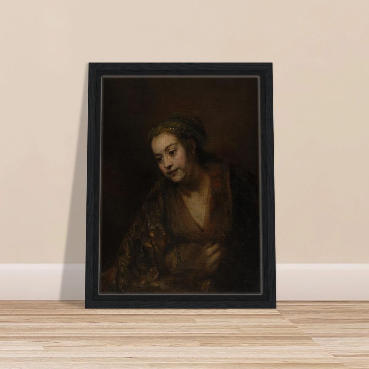 A softly lit woman looks downward while holding her robe against a dark brown background.