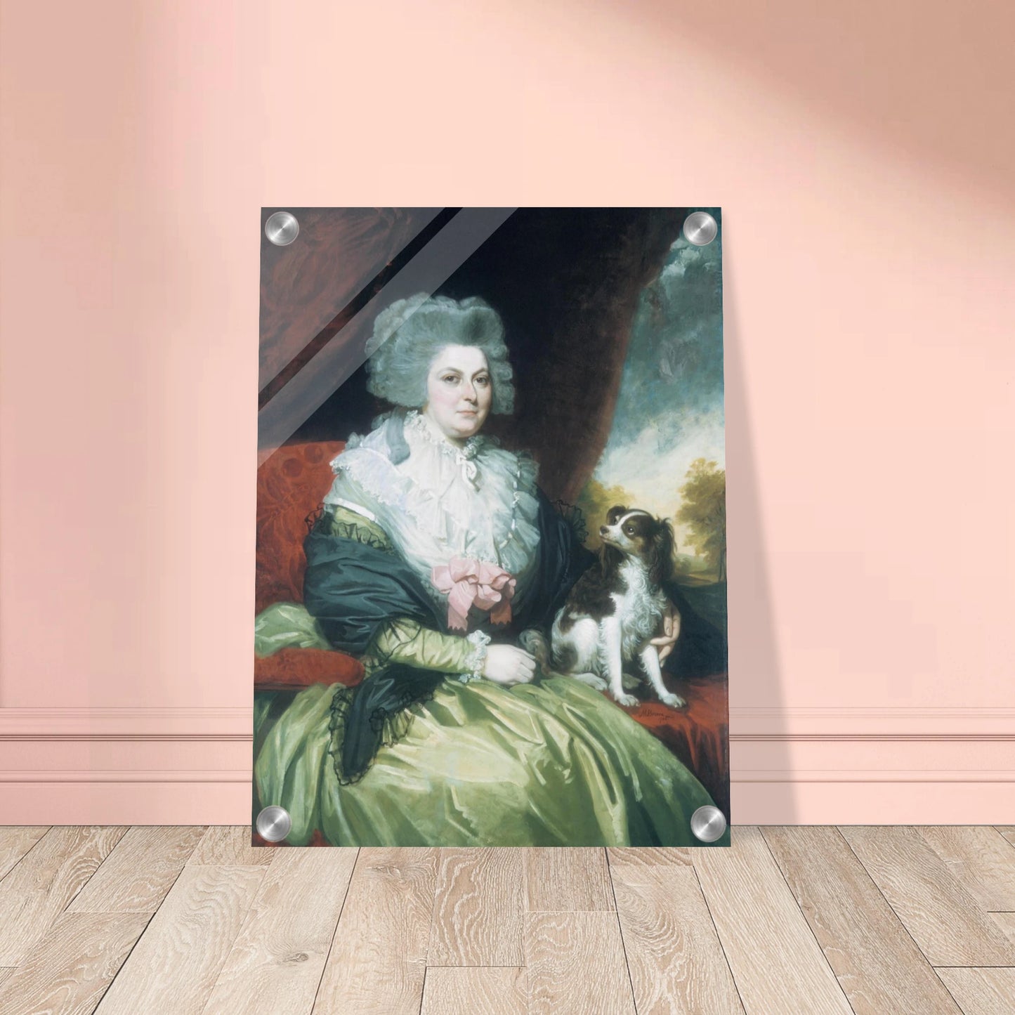 Woman in a green dress sits beside a small black and white dog in a formal portrait