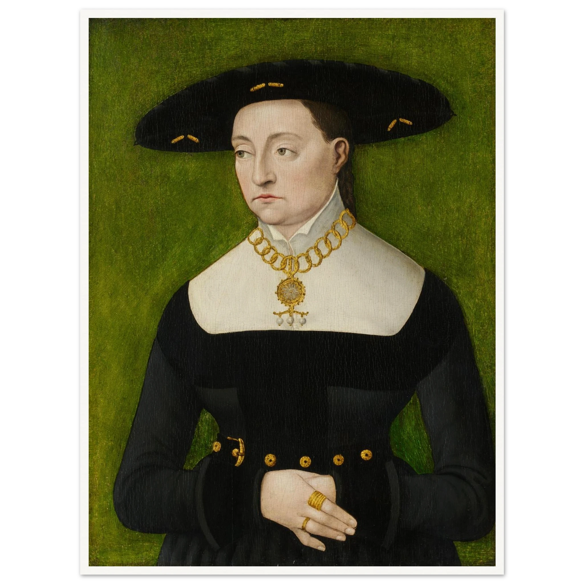 A woman in a black dress and broad hat poses against a green background with gold jewelry.