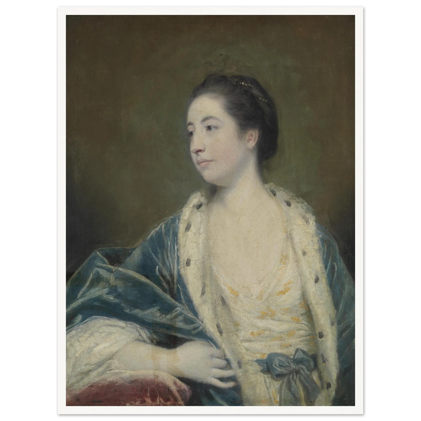 Young woman in a blue robe with fur trim poses against a dark green background
