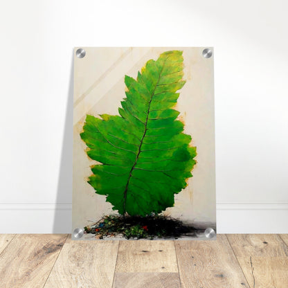 A large, vivid green leaf standing upright against a light background, with intricate veins and subtle texture, emerging from a small mound of organic debris.