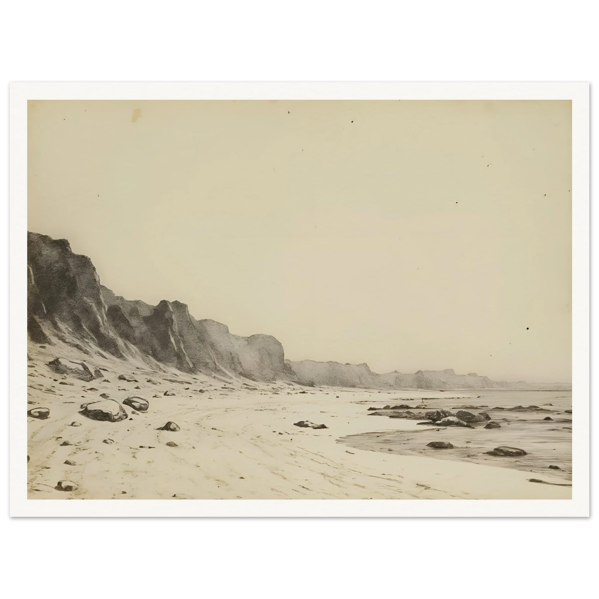 Minimal coastal landscape with pale sandy shore, rugged cliffs, scattered stones, and calm sea rendered in soft monochrome tones.