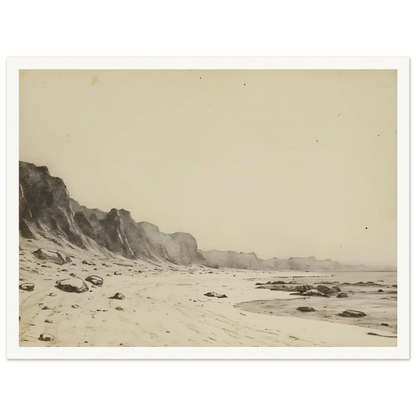 Minimal coastal landscape with pale sandy shore, rugged cliffs, scattered stones, and calm sea rendered in soft monochrome tones.