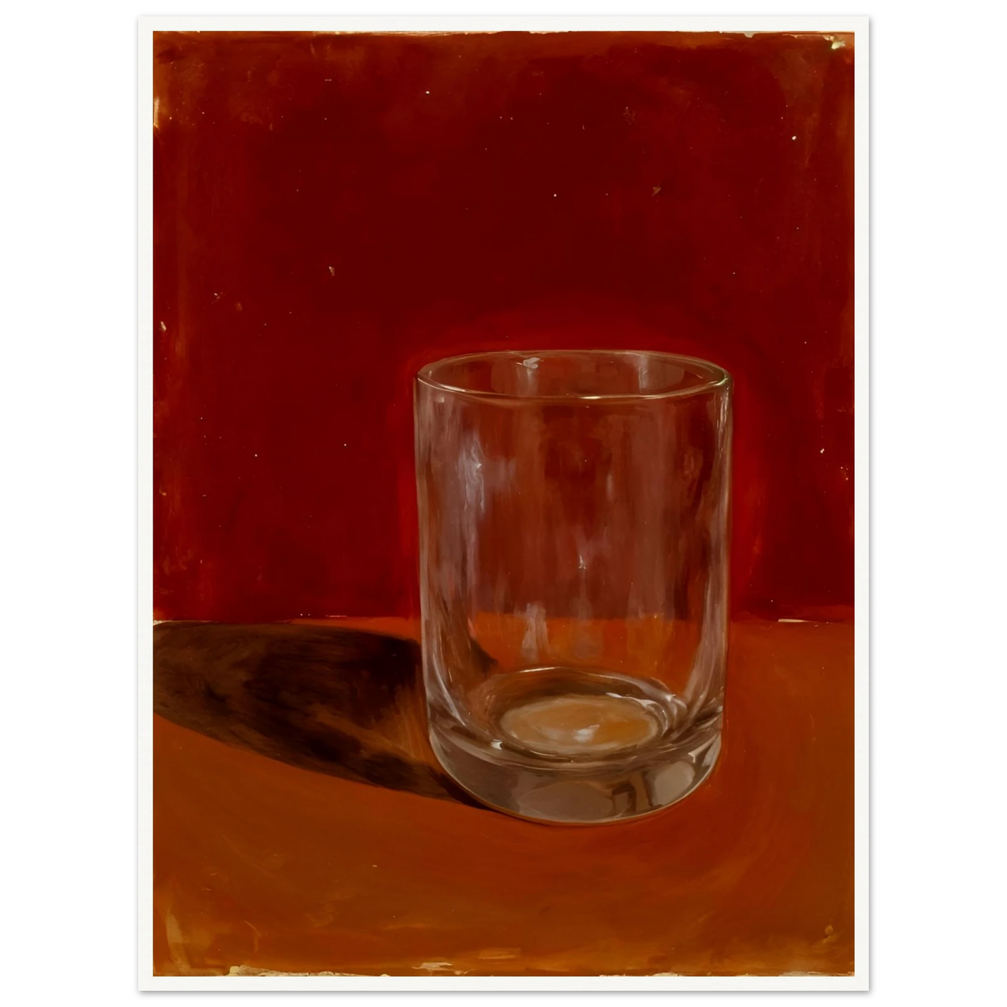 Transparent drinking glass casting a soft shadow on a warm orange and red background.