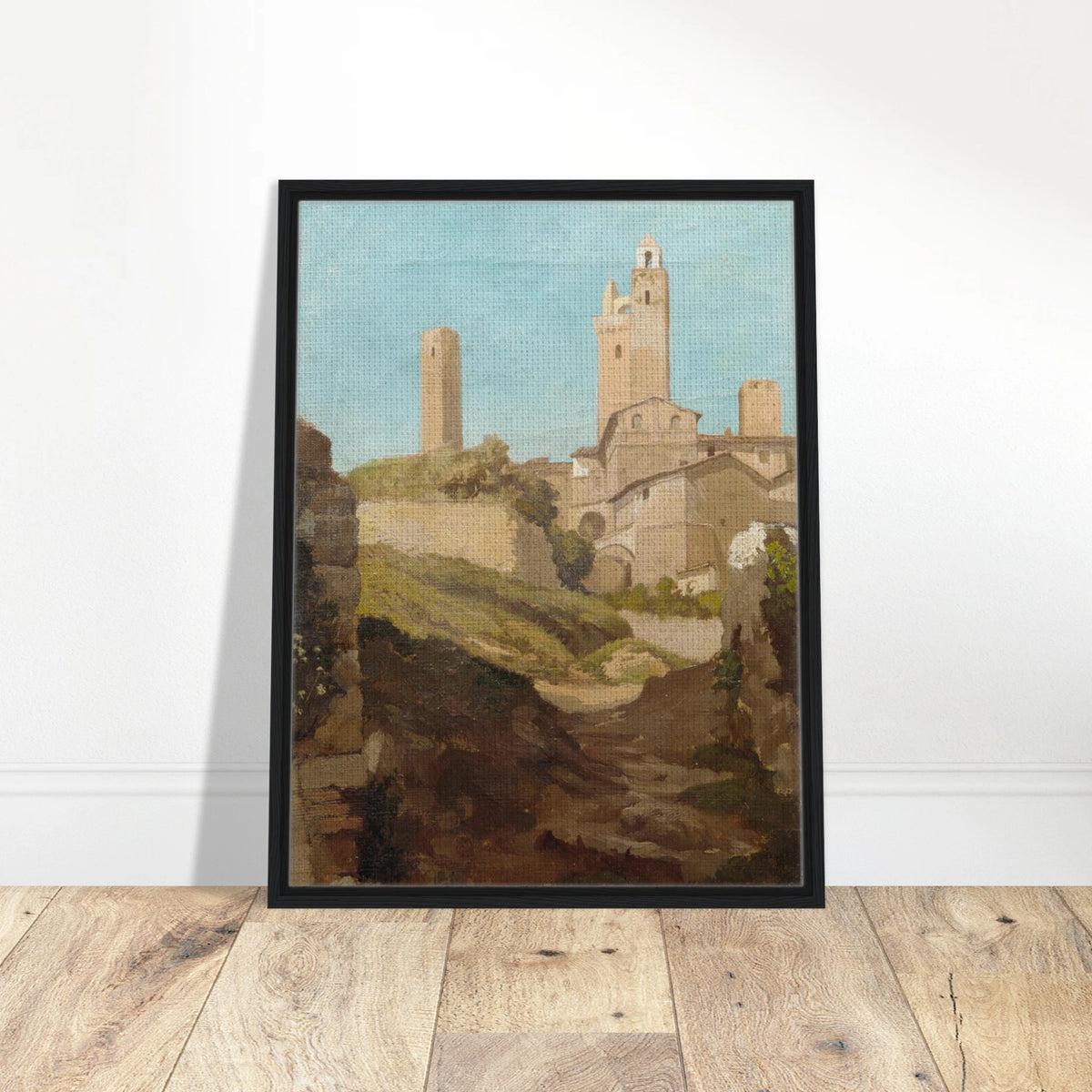 Medieval towers rise above San Gimignano’s sunlit hill town and rough path under a pale blue sky.
