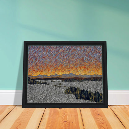 Vibrant orange sunset over distant mountains with textured sky and patterned fields in the foreground.