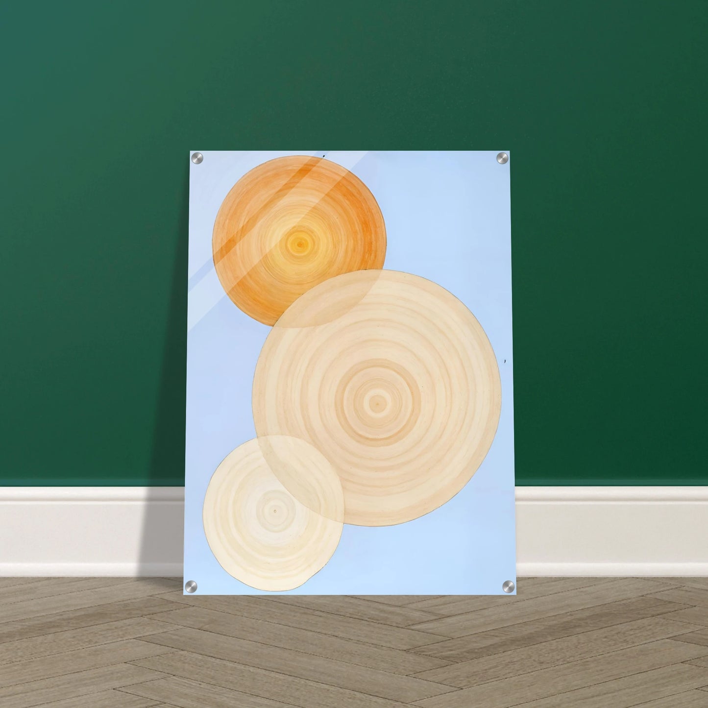 Three overlapping concentric circles in warm orange and beige tones float on a soft blue background like suns in serene orbit.