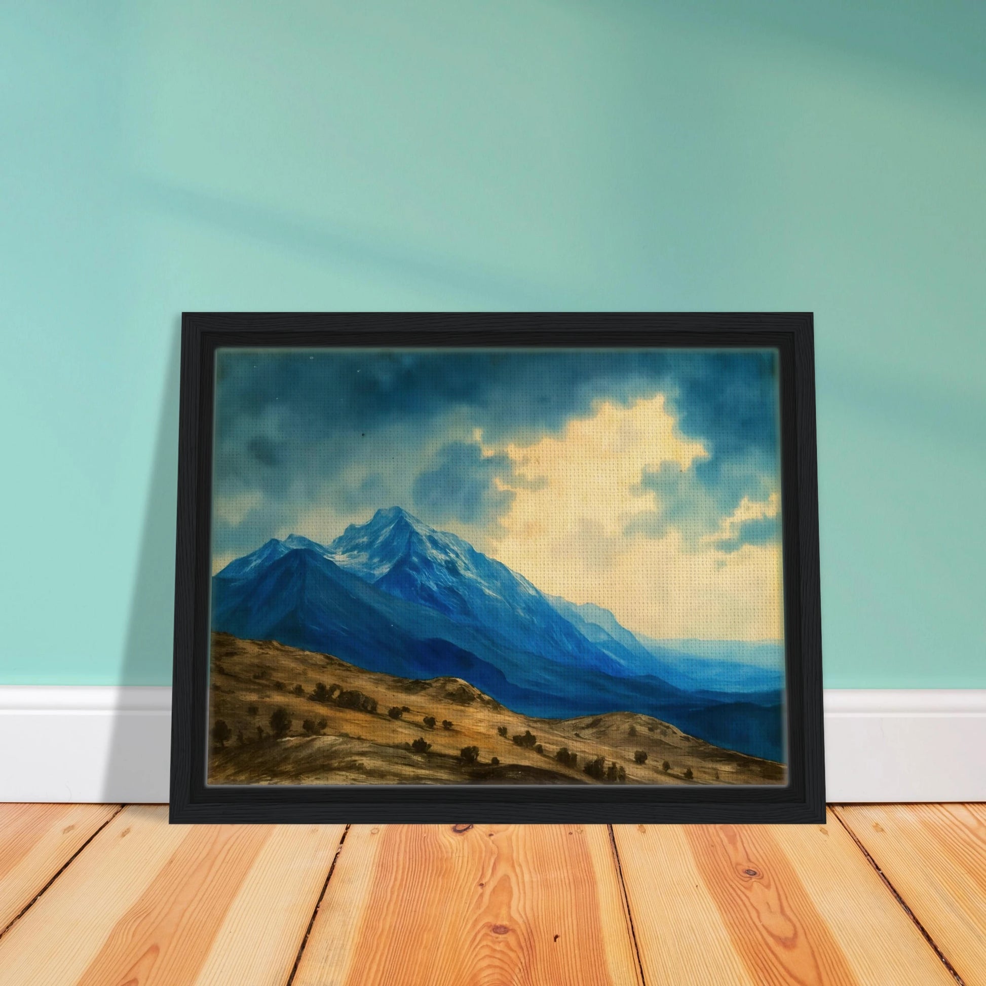 Majestic blue mountain peaks rise above golden rolling plains beneath luminous clouds, blending grandeur, distance, and tranquil wilderness.