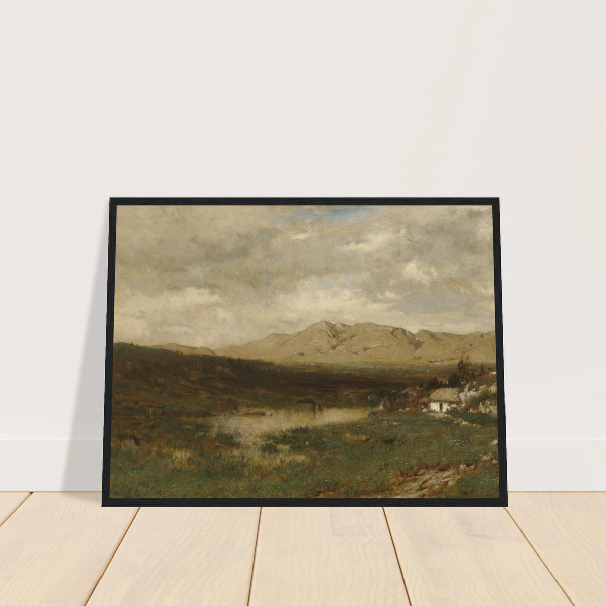 A rural cottage sits below distant mountains beneath a broad, cloudy sky in the Irish countryside.
