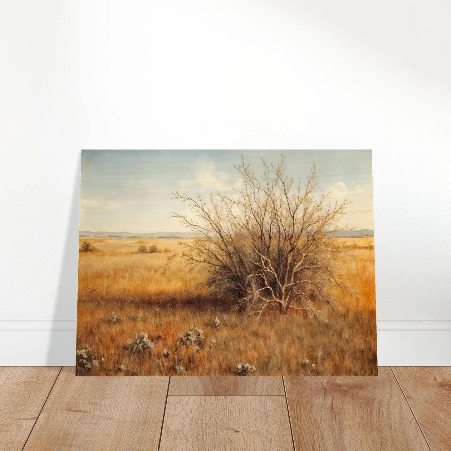 A golden-brown field stretches into the distance under a pale blue sky, with a single dry bush standing in quiet solitude.