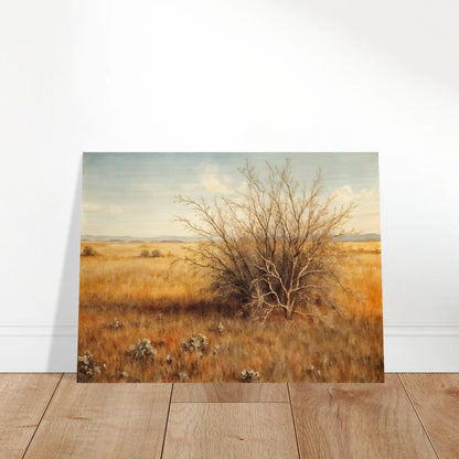 A golden-brown field stretches into the distance under a pale blue sky, with a single dry bush standing in quiet solitude.
