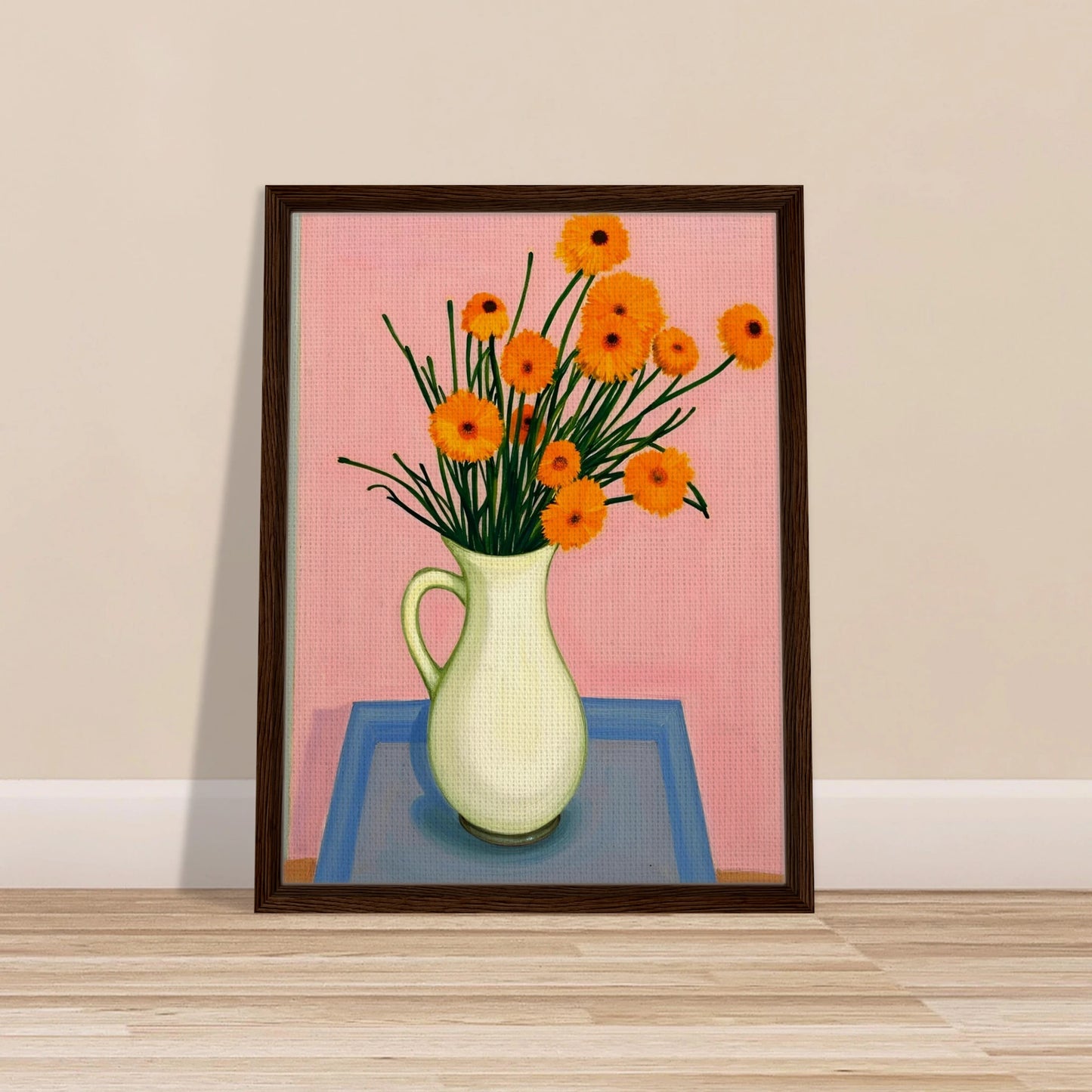 A vase of orange daisies with green stems against a soft pink background, radiating warmth and joy on a pastel tabletop.