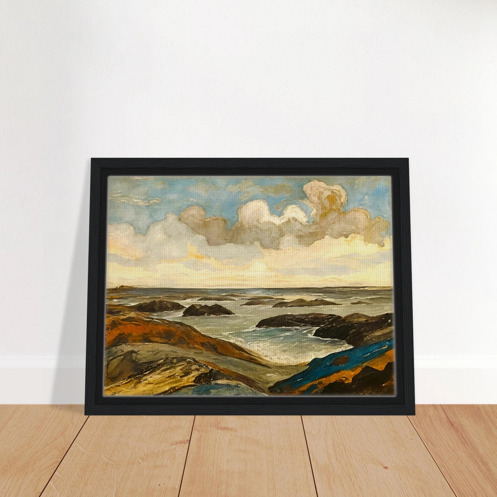 Rocky seashore with dark stones and rolling waves beneath a dramatic sky of shifting clouds and golden sunlight.