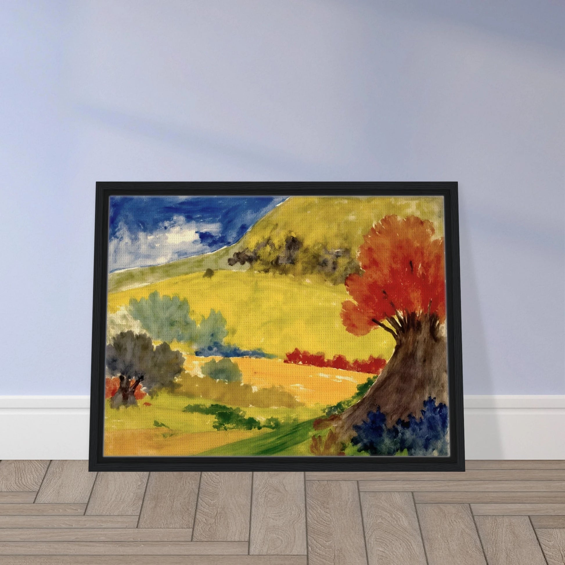 Red tree rises beside golden hills, green fields, and a deep blue sky in a bright countryside scene.