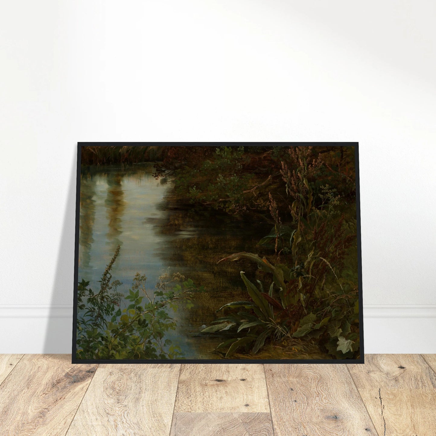 Calm water reflects trees beside dense riverbank plants and grasses