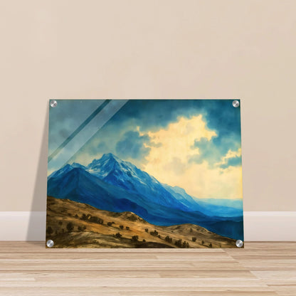 Majestic blue mountain peaks rise above golden rolling plains beneath luminous clouds, blending grandeur, distance, and tranquil wilderness.
