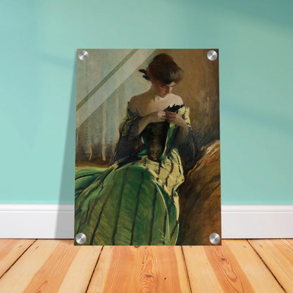 Woman in green and black evening gown pins a detail at her neckline against a muted background