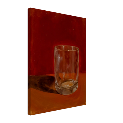 Transparent drinking glass casting a soft shadow on a warm orange and red background.
