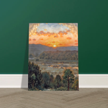 A glowing sunset over misty hills and a river valley, where the sky burns in orange light above soft green trees.