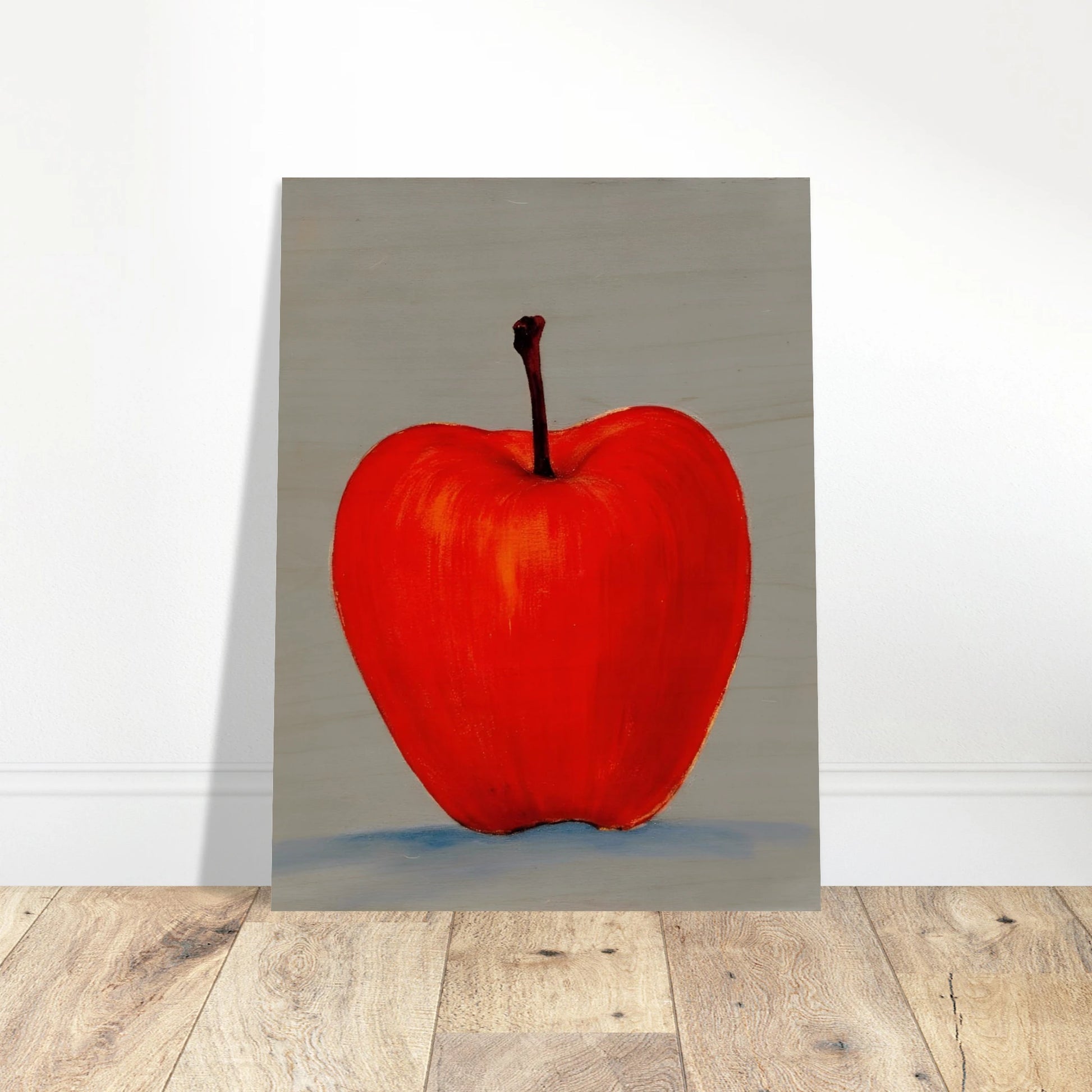 A vivid red apple stands alone against a muted gray backdrop, its glowing form balancing simplicity, boldness, and quiet elegance.
