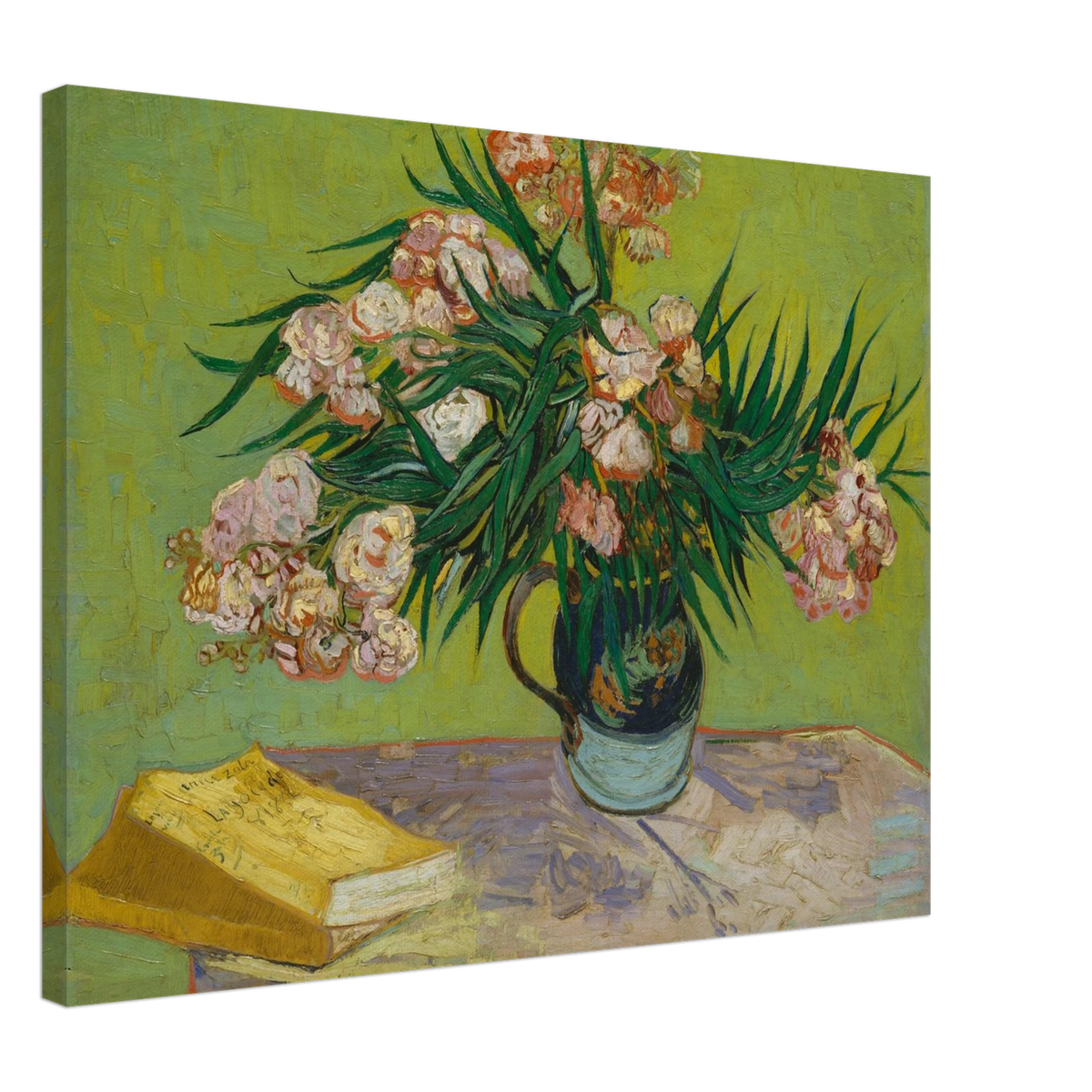 Pink oleanders bloom in a vase beside a yellow book on a green table.