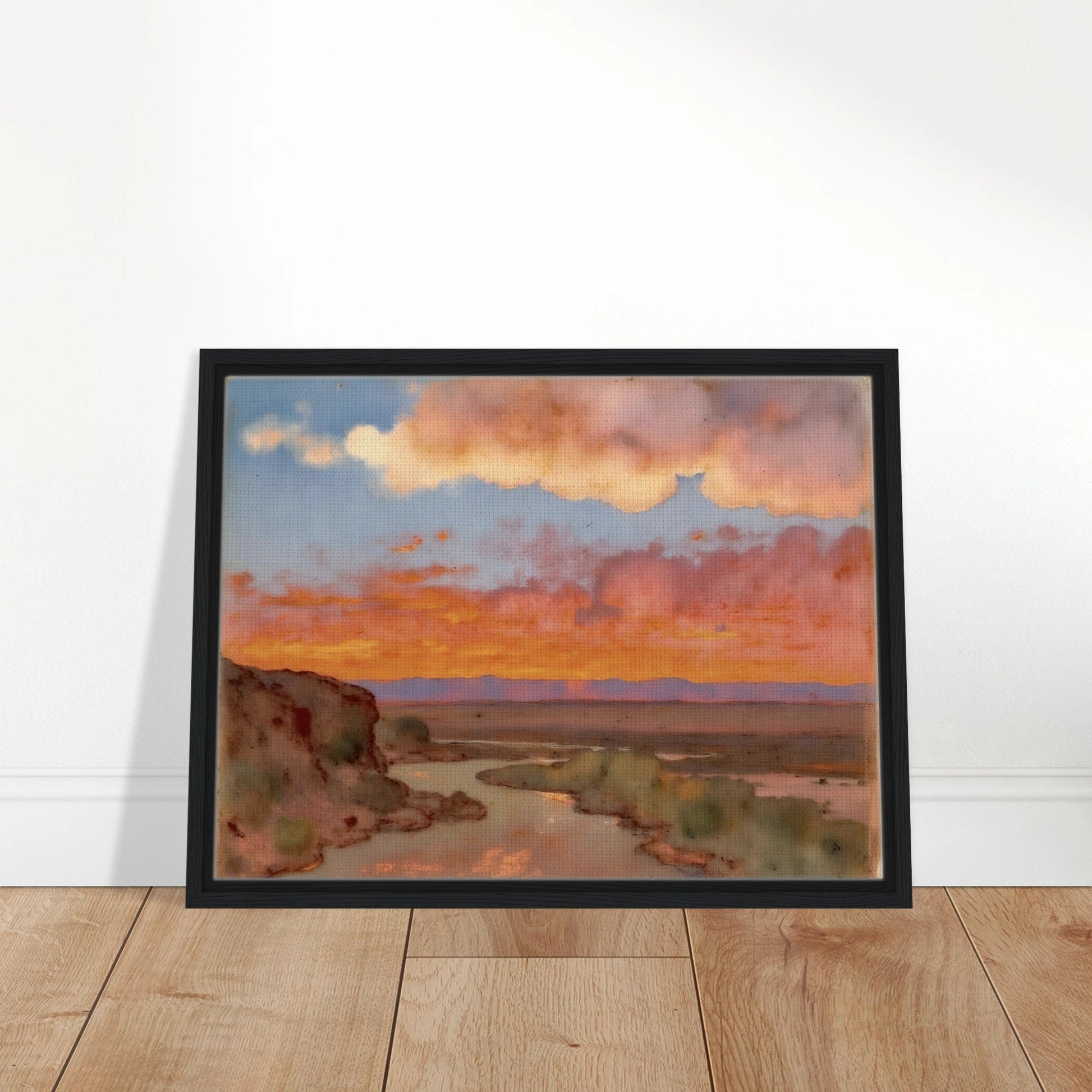 Soft desert river winding beneath glowing orange and pink sunset clouds, with distant plains and muted cliffs in a serene landscape.