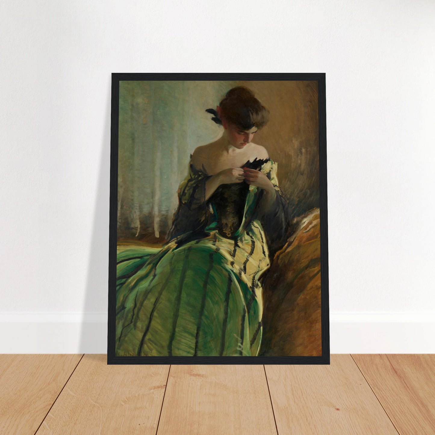 Woman in green and black evening gown pins a detail at her neckline against a muted background