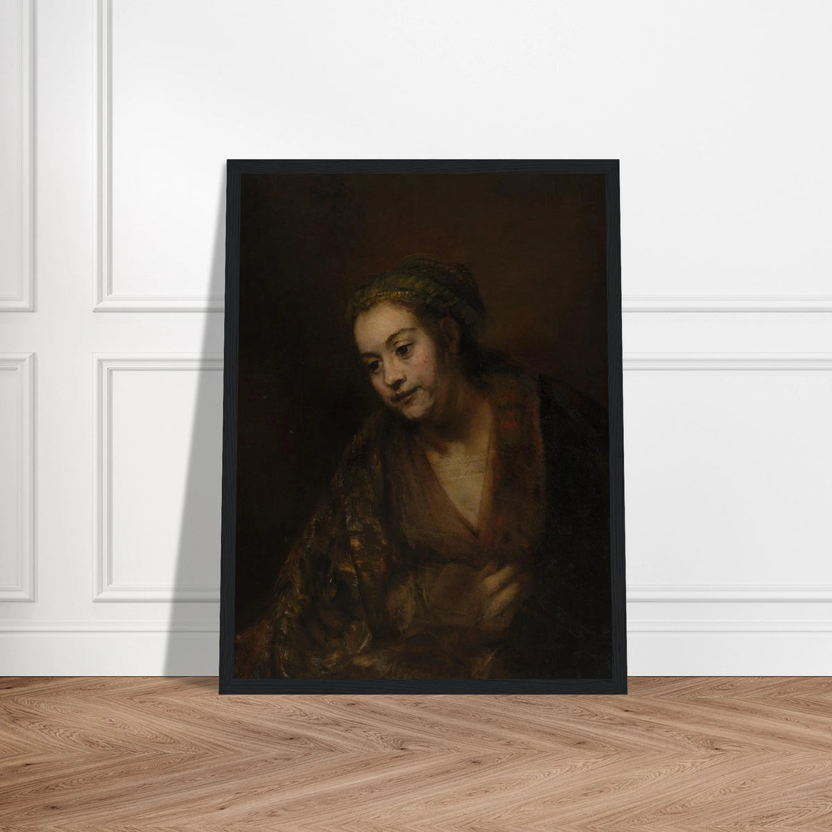 A softly lit woman looks downward while holding her robe against a dark brown background.