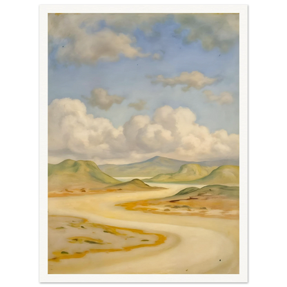 Soft clouds drift above pale hills, sandy curves, and quiet water under a blue sky.