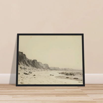 Minimal coastal landscape with pale sandy shore, rugged cliffs, scattered stones, and calm sea rendered in soft monochrome tones.