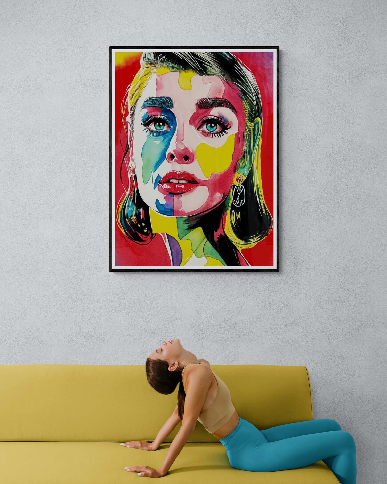 Woman stretching on a yellow sofa beneath a colorful pop art portrait featuring vibrant hues and bold design in a modern interior.